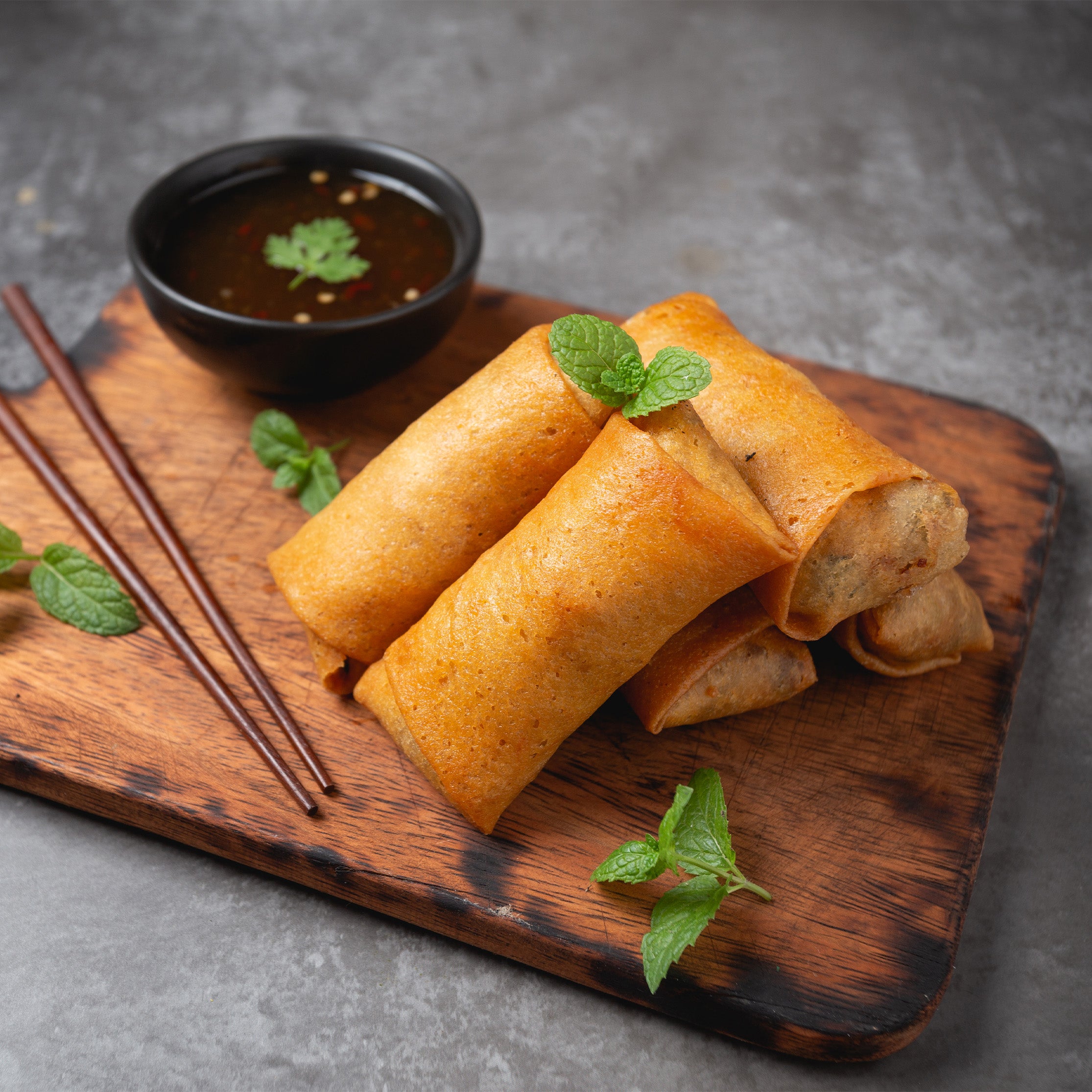 Crispy vegetable spring rolls with fresh mixed vegetables in golden pastry. Served with Mi Sauce. Order the best spring rolls near you from MiBurger for takeawa