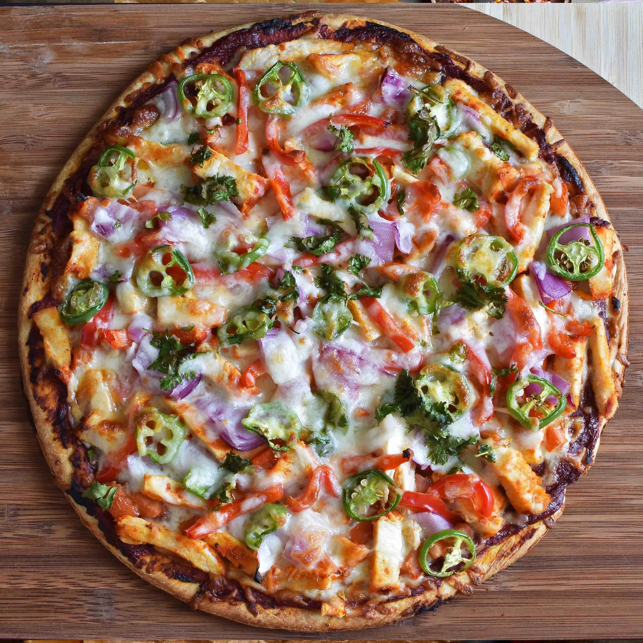 Halal tandoori chicken pizza with spicy tandoori sauce - Mi Burger Nottingham