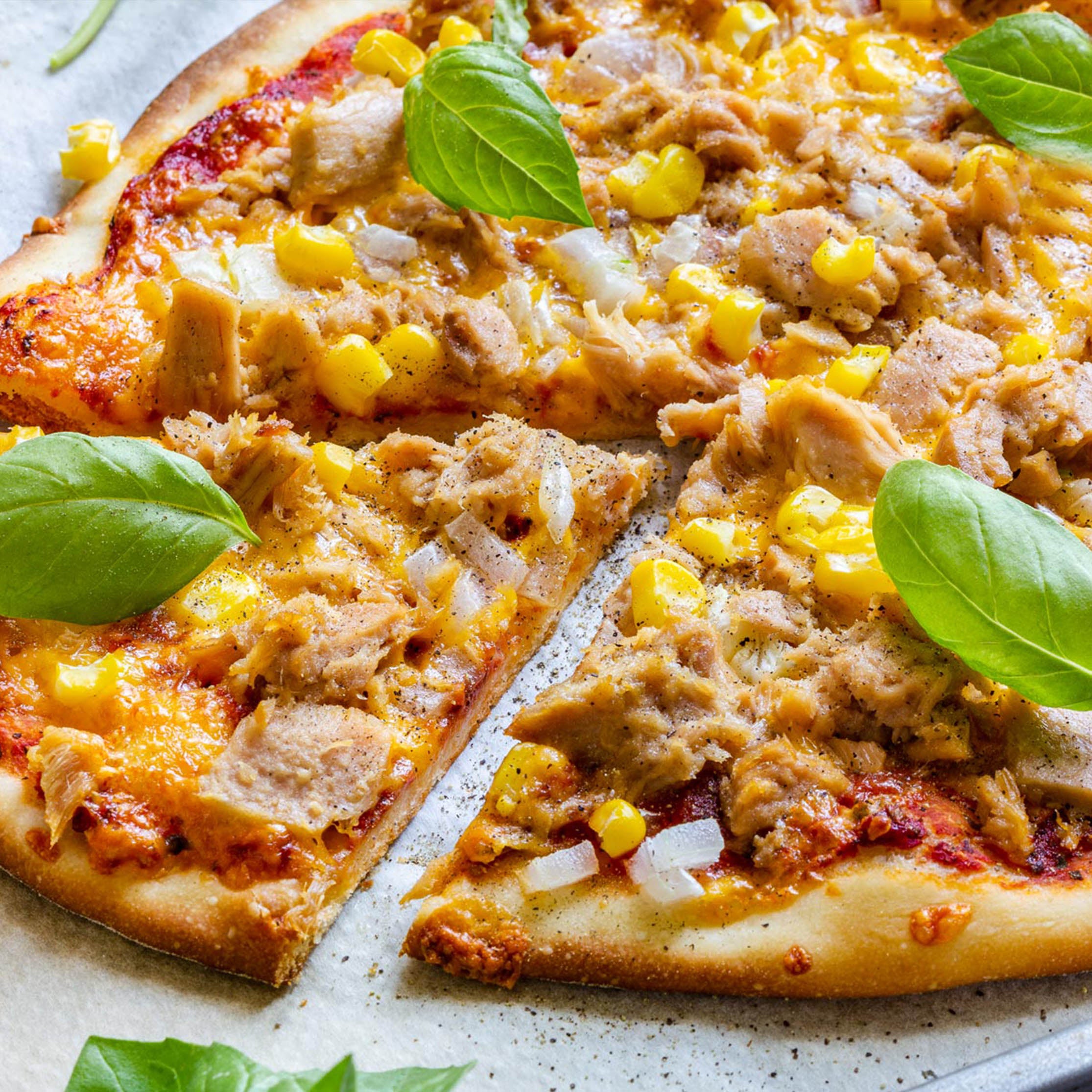 Fresh halal tuna pizza with tuna, sweet corn and onions on tomato sauce with cheese. Order the best halal tuna pizza near you from MiBurger for takeaway or delivery.